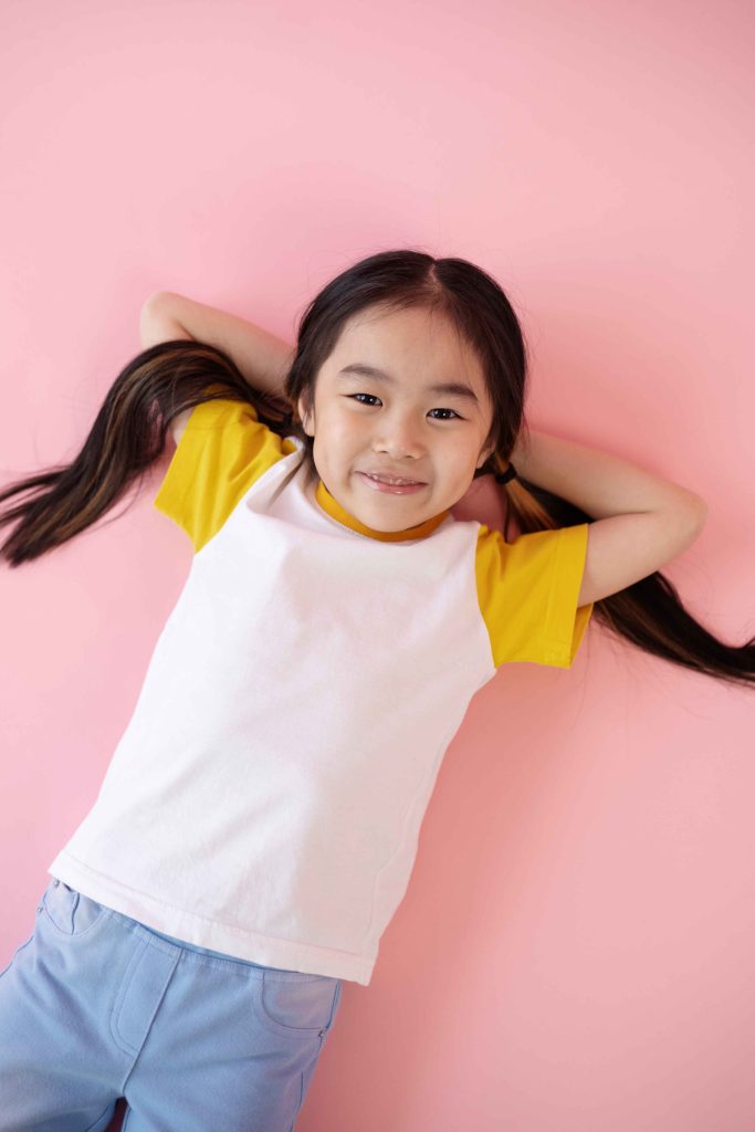 asian girl laying pink floor 1 11zon